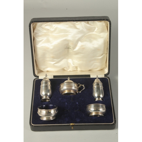 1867 - A FIVE PIECE SILVER CONDIMENT SET, cased. Chester 1910.