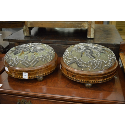 240 - A pair of Victorian inlaid walnut circular foot stools with bead work upholstery.