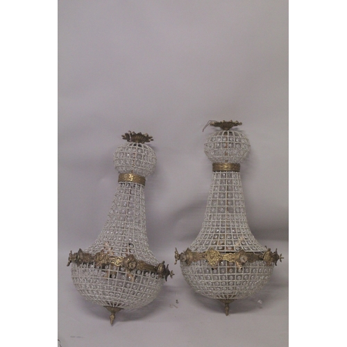 1017 - A PAIR OF CRYSTAL BEAD BAG CHANDELIERS. 2ft 8ing long.