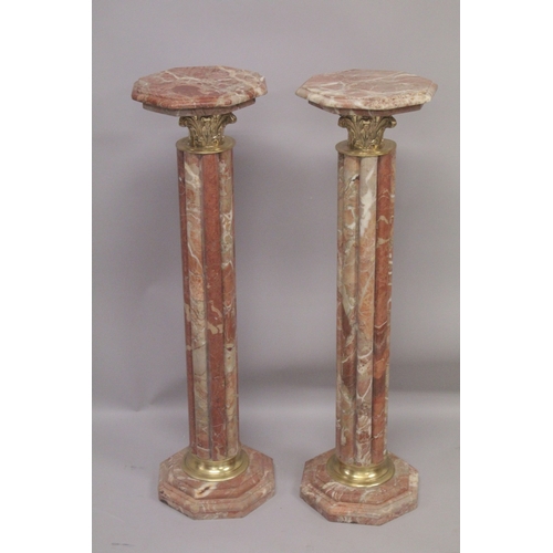 1027 - A PAIR OF RED MARBLE CLUSTER COLUMNS with gilt metal mounts. 3ft 4ins high.