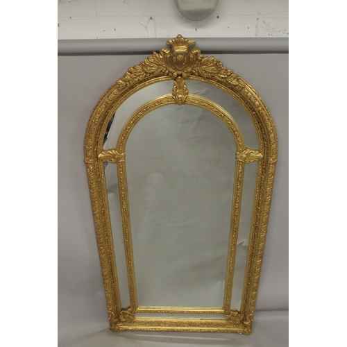 1031 - A GOOD LARGE GILT FRAMED VICTORIAN STYLE ARCH TOP MIRROR. 7ft 4ins x 3ft 8ins wide.