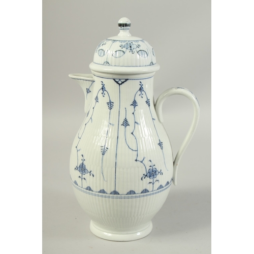 1068 - A LARGE VOLKSTEDT COFFEE POT decorated with a stylised flower decoration in under glaze blue. Circa.... 