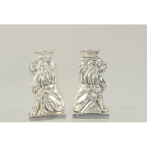 1460 - A PAIR OF SILVER PLATED ROYAL LIONS SALT AND PEPPERS. 3.25