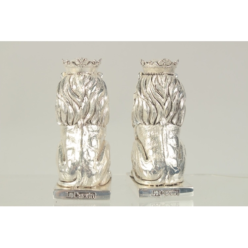 1460 - A PAIR OF SILVER PLATED ROYAL LIONS SALT AND PEPPERS. 3.25