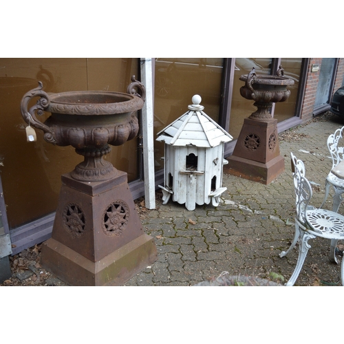 1035A - A GOOD LARGE PAIR OF VICTORIAN STYLE CAST IRON TWIN HANDLED PEDESTAL URNS, on tapering square bases.... 