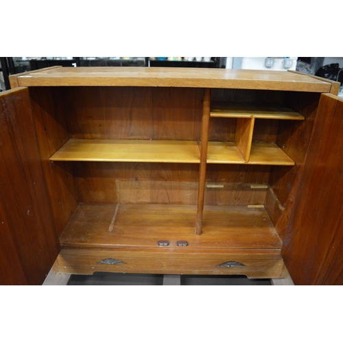 153 - A teak cupboard.