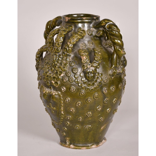 193 - Early 15th Century, a ceramic medieval vessel, scrolling handles and applied decoration, 14.5