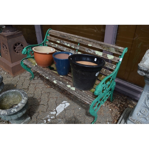 11 - A cast metal and wooden slatted garden bench.