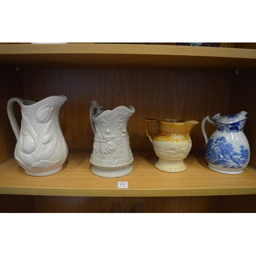 111 - Three decorative jugs.