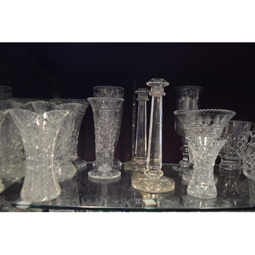 115 - A large quantity of cut glass vases, decanters etc.