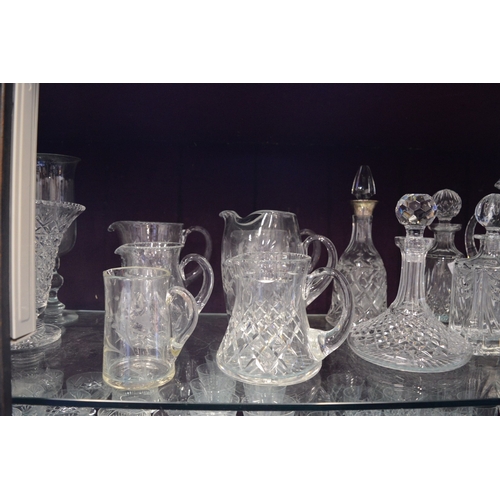 115 - A large quantity of cut glass vases, decanters etc.