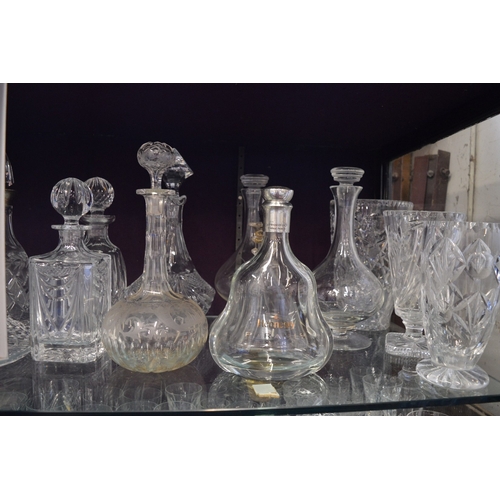 115 - A large quantity of cut glass vases, decanters etc.