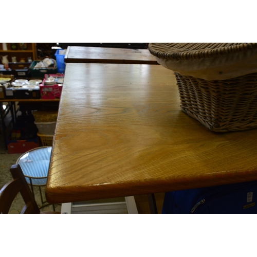 155 - An oak plank top refectory style dining table with wrought iron supports.