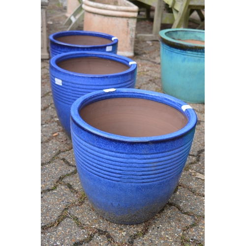 16 - A set of three blue glazed terracotta planters.