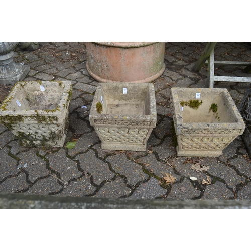 20 - A set of three reconstituted stone square shaped garden planters.