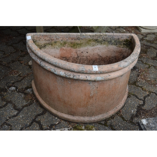 21 - A large pair of terracotta demi-lune planters.