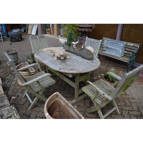 25 - Hardwood extending garden table with a set of four folding armchairs.