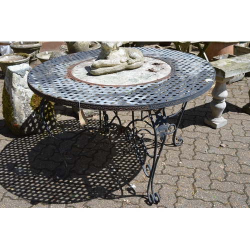 37 - A circular metal garden table inset with a pottery plaque.