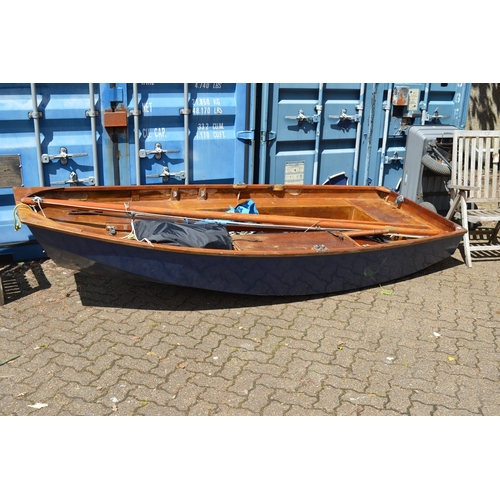 42 - A painted and varnished wooden sailing dingy with accessories.