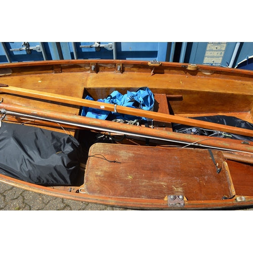 42 - A painted and varnished wooden sailing dingy with accessories.