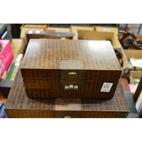 575 - Graduated set of three Chinese storage boxes.