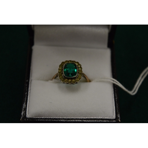 997 - A 9ct gold ring set with central green stone, size M.