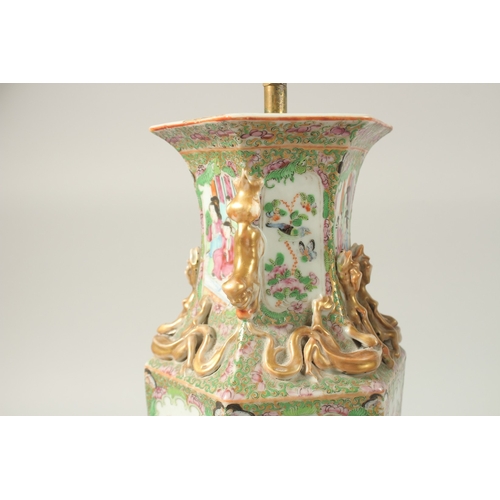 16 - A FINE PAIR OF CHINESE CANTON FAMILLE ROSE PORCELAIN VASE LAMPS, painted with panels of figures, flo... 