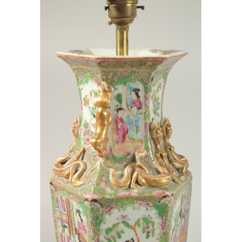 16 - A FINE PAIR OF CHINESE CANTON FAMILLE ROSE PORCELAIN VASE LAMPS, painted with panels of figures, flo... 