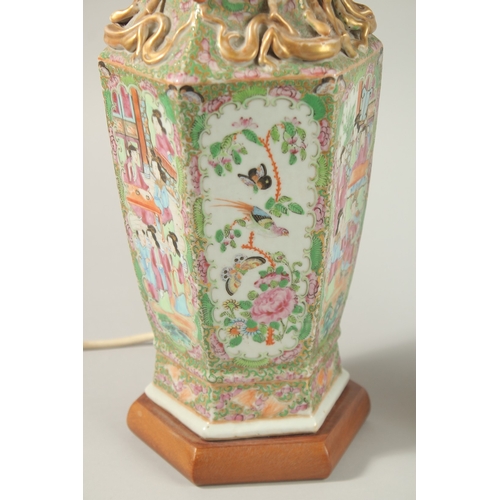 16 - A FINE PAIR OF CHINESE CANTON FAMILLE ROSE PORCELAIN VASE LAMPS, painted with panels of figures, flo... 