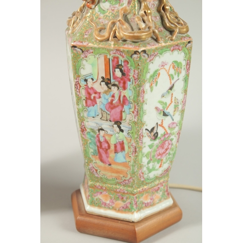 16 - A FINE PAIR OF CHINESE CANTON FAMILLE ROSE PORCELAIN VASE LAMPS, painted with panels of figures, flo... 