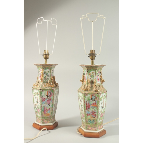 16 - A FINE PAIR OF CHINESE CANTON FAMILLE ROSE PORCELAIN VASE LAMPS, painted with panels of figures, flo... 