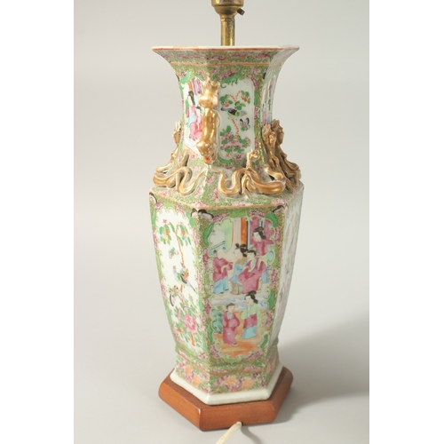 16 - A FINE PAIR OF CHINESE CANTON FAMILLE ROSE PORCELAIN VASE LAMPS, painted with panels of figures, flo... 