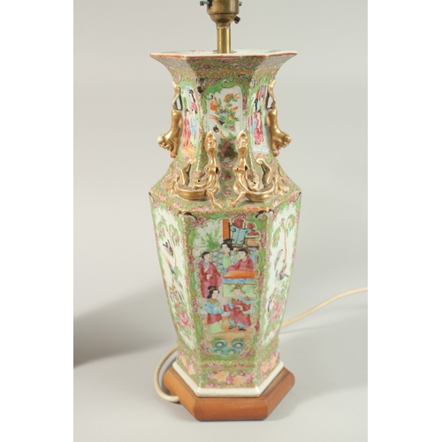 16 - A FINE PAIR OF CHINESE CANTON FAMILLE ROSE PORCELAIN VASE LAMPS, painted with panels of figures, flo... 