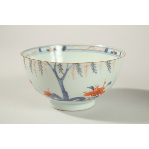 25 - AN 18TH CENTURY CHINESE BLUE AND RED PORCELAIN BOWL AND DISH, the dish painted with temples and tree... 