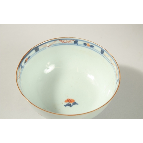 25 - AN 18TH CENTURY CHINESE BLUE AND RED PORCELAIN BOWL AND DISH, the dish painted with temples and tree... 