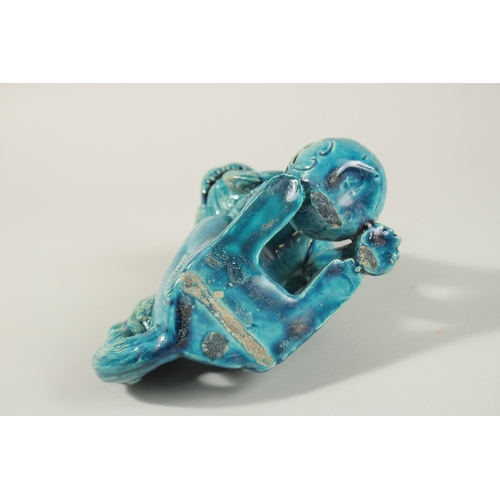 31 - A CHINESE TURQUOISE GLAZE PORCELAIN LION DOG, 20.5cm high.