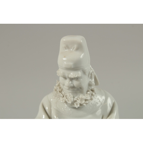 33 - A FINE BLANC-DE-CHINE FIGURE of a bearded man, 21cm high.