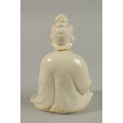 34 - A 17TH CENTURY BLANC-DE-CHINE SEATED FIGURE, 22cm high.