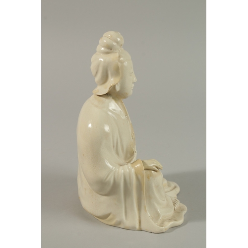 34 - A 17TH CENTURY BLANC-DE-CHINE SEATED FIGURE, 22cm high.