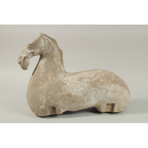 35 - A LARGE HAN DYNASTY CARVED STONE HORSE, 44cm long.