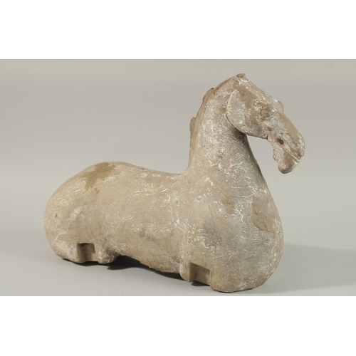 35 - A LARGE HAN DYNASTY CARVED STONE HORSE, 44cm long.