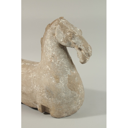 35 - A LARGE HAN DYNASTY CARVED STONE HORSE, 44cm long.