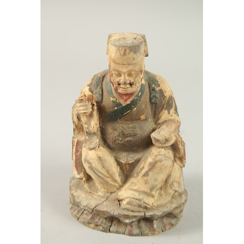 377 - A CHINESE CARVED WOOD SEATED FIGURE, 18cm high.