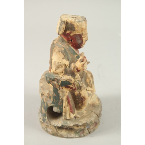 377 - A CHINESE CARVED WOOD SEATED FIGURE, 18cm high.