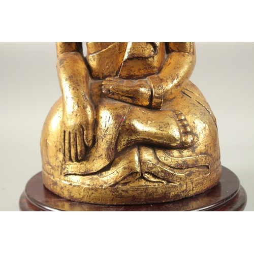 380 - A LARGE GILDED CARVED WOODEN BUDDHA WITH OVAL HARDWOOD STAND, Buddha 52cm high, base 29cm wide, wood... 