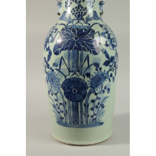 42 - A LARGE CHINESE PALE CELADON BLUE AND WHITE PORCELAIN VASE, painted with a spray of flora, the neck ... 