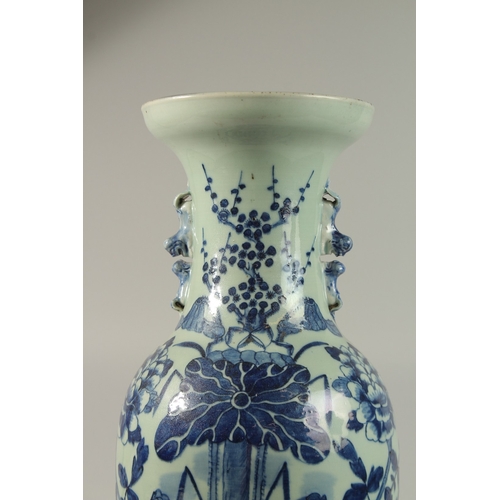 42 - A LARGE CHINESE PALE CELADON BLUE AND WHITE PORCELAIN VASE, painted with a spray of flora, the neck ... 