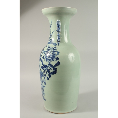 42 - A LARGE CHINESE PALE CELADON BLUE AND WHITE PORCELAIN VASE, painted with a spray of flora, the neck ... 