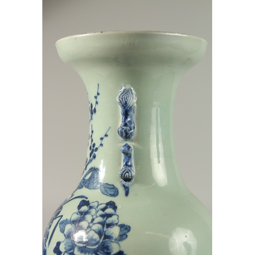 42 - A LARGE CHINESE PALE CELADON BLUE AND WHITE PORCELAIN VASE, painted with a spray of flora, the neck ... 