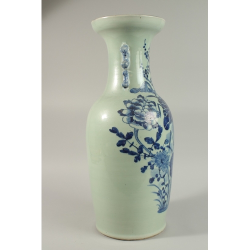 42 - A LARGE CHINESE PALE CELADON BLUE AND WHITE PORCELAIN VASE, painted with a spray of flora, the neck ... 